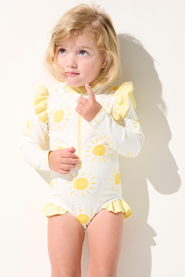 Maillot de bain anti-UV manches longues - Flores pour enfant, jaune avec motifs soleil, idéal pour la protection solaire.