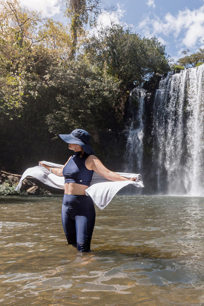 Haut de maillot de bain anti-UV - Malta, femme en maillot et chapeau, profitant d'une cascade en été.
